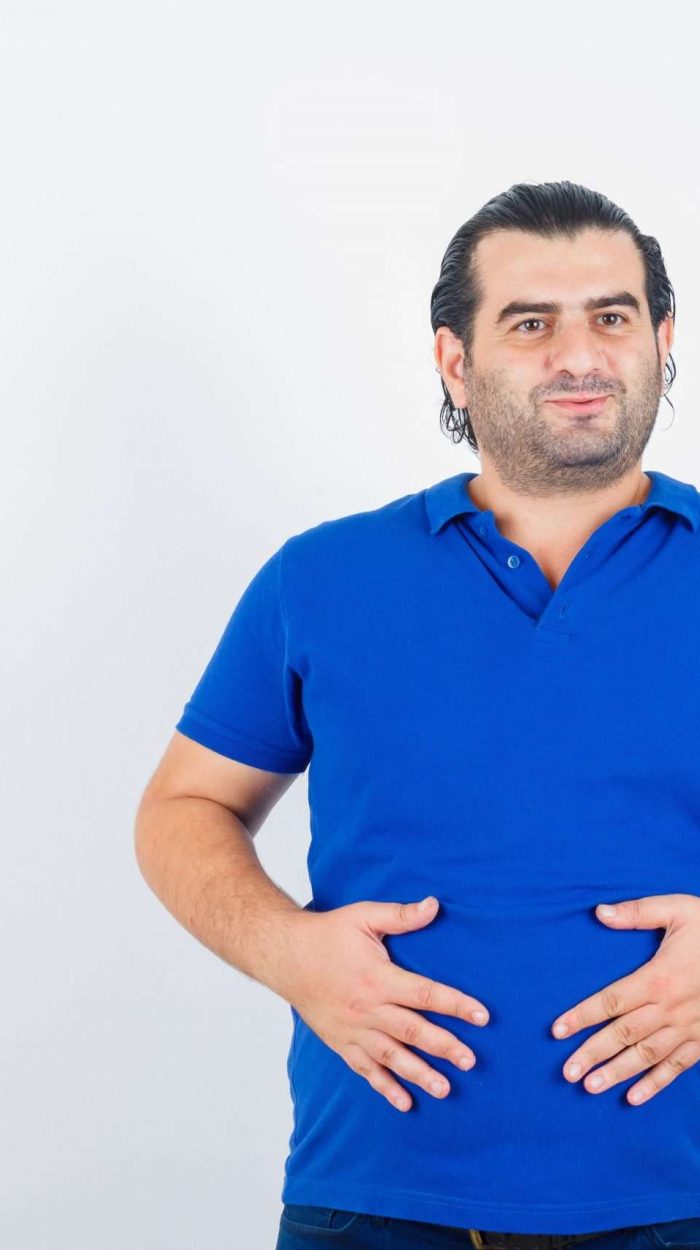 middle-aged-man-polo-t-shirt-keeping-hands-stomach-looking-joyful-min-scaled-1